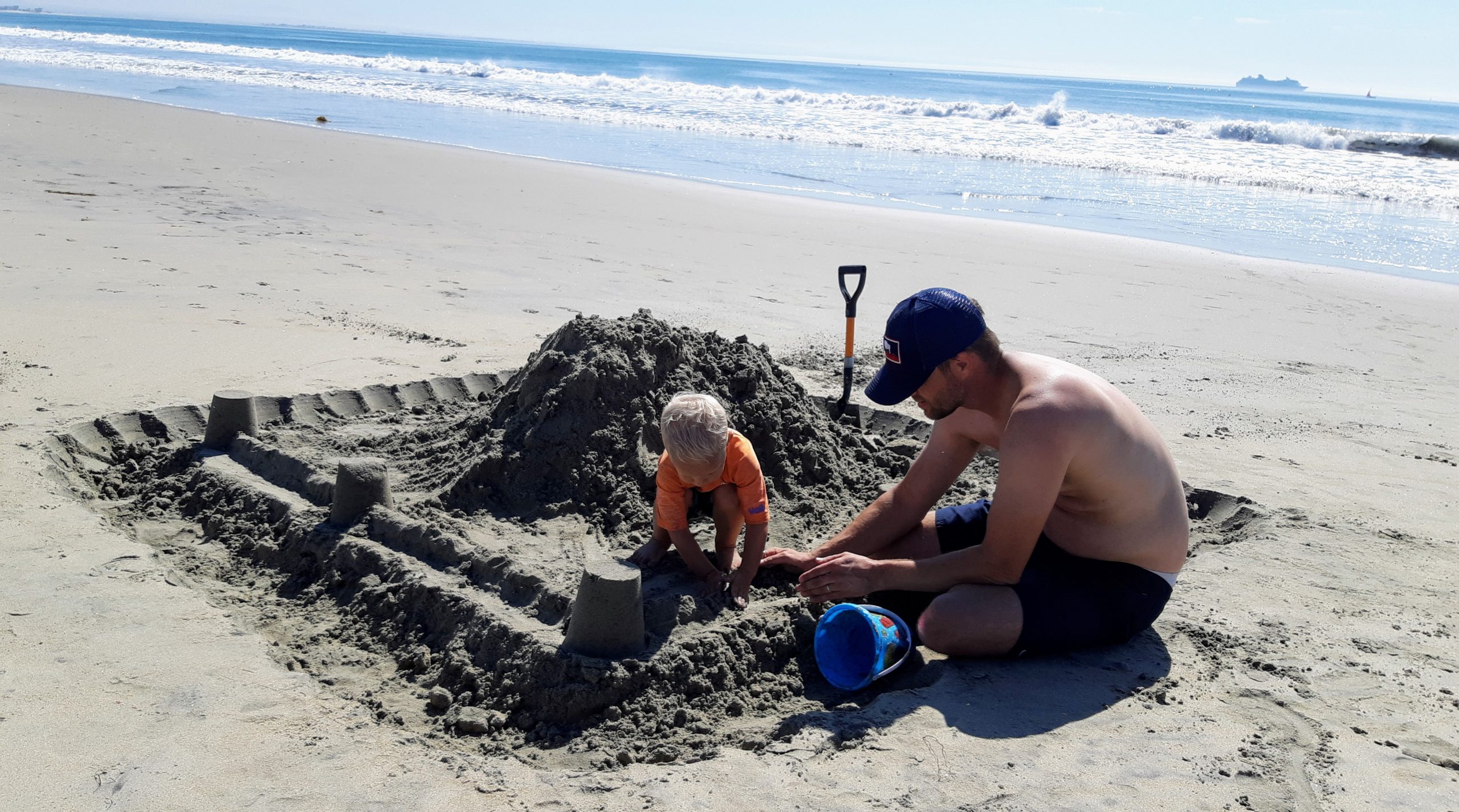 A grandson with his father enjoying the "immensity of the sea" Building a castle on Coronado Island